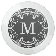 a black and white monogrammed plate with the letter m in it's center