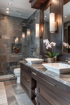 a bathroom with two sinks and a large mirror in the corner, along with dark wood cabinets