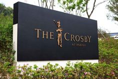 the crosby at holbro sign in front of bushes