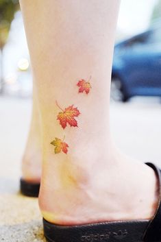 a woman's foot with leaves on it