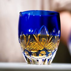 a blue glass sitting on top of a table