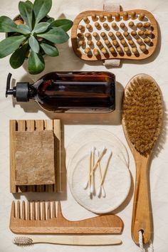 various items are arranged on a table including toothbrushes, combs and soap