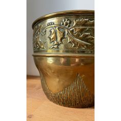 a golden bowl sitting on top of a wooden table