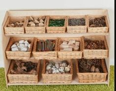 a wooden shelf filled with lots of different types of items in baskets on top of green carpeted floor