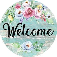 a sign that says welcome with flowers on it