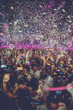 confetti is thrown in the air over a crowd at a concert or party