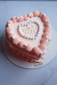 a heart shaped cake with pearls on top