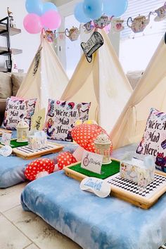 several teepee tents are set up in the living room with pillows and other decorations