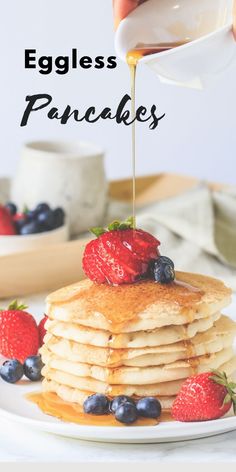 a stack of pancakes with syrup being drizzled on top