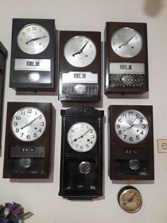 several clocks are arranged on the wall with different times