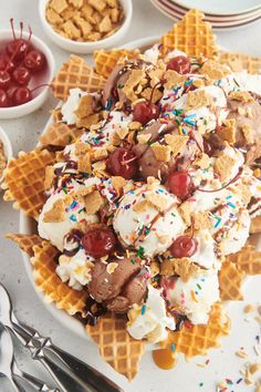 waffles with ice cream, cherries and sprinkles on them