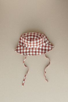 Product photos - terracotta gingham. Our baby bucket hat will help to stay protected and keep it cute. Tailored to shade the face and ears along with side ties to keep the hat secure. A classy and comfortable choice for any forecast. Lightweight, cozy and charming. This baby bucket hat is designed to be comfortably loose-fitting and allow for growth as the baby grows. Baby Bucket Hat, Gingham Linen, Baby Grows, Product Photos, Gender Neutral Baby, Baby Clothing, Clothing Items, Gingham, The Face