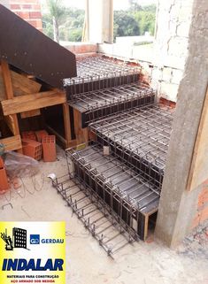 several cages are stacked on top of each other in the middle of a building under construction