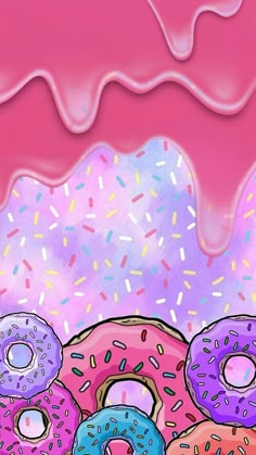 there are many donuts with sprinkles on the pink frosted surface