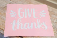 a pink sticker that says give thanks on it