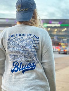 Extra soft, professionally screen printed St. Louis Hockey sweatshirt. These oatmeal heather sweatshirts feature a blue screen printed design on the front and back of the shirt.  Get the perfect gift for your favorite Blues fan with this vintage style hockey design. The back design features some special details only a true fan would recognize: a nod the towel guy, retired Blues numbers, Louie, Gloria, and more.  Fit: These are are true unisex sizing. Size up 1-2 sizes for an oversized look. See Throwback Cotton Sweatshirt With Screen Print, Soft-washed Blue Crew Sweatshirt, Blue Soft-washed Crew Sweatshirt, Throwback Fan Merchandise Cotton Sweatshirt, Throwback Cotton Sweatshirt For Fan Merchandise, Cotton Fan Apparel Sweatshirt, Cotton Sweatshirt For Fan Merchandise, Blue Crew Neck Soft-washed Sweatshirt, Urban Sweatshirt With Back Print And Crew Neck