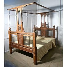 an old fashioned wooden bed in a room