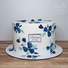 a white cake with blue flowers on it