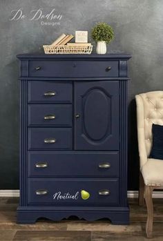 a white chair sitting next to a blue dresser