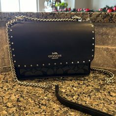 This Purse Is Sleek!!! Leather With Silver Studs Silver Chain Smooth Suede Inside 3 Pockets And 1 Additional Zippered Pocket 8.5in X 6in X 3.5in Coach Clutch Bag With Chain Strap, Coach Evening Bags With Chain Strap, Coach Crossbody Bag With Chain Strap, Designer Coach Shoulder Bag With Chain Strap, Coach Leather Shoulder Bag With Chain Strap, Coach Evening Shoulder Bag With Branded Hardware, Coach Evening Flap Bag With Adjustable Strap, Designer Coach Flap Bag For Evening, Bags Coach