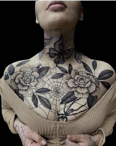 a woman with tattoos on her chest and arms