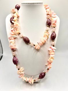 This vintage necklace is a stunning piece of art with beautiful pink rose quartz stones, shell and glass beads. It is a unique necklace that will complement any outfit. The multicolor beads are intricately designed to create a beaded necklace that is both stylish and charming. The necklace is perfect for women who love art and vintage jewelry. The necklace is made with high-quality materials and has a timeless appeal that will never go out of style. Unique Pink Necklace With Natural Stones, Pink Bohemian Crystal Necklace With Gemstone Beads, Bohemian Pink Crystal Necklace With Gemstone Beads, Bohemian Pink Gemstone Bead Necklaces, Handmade Bohemian Rose Quartz Beaded Necklaces, Handmade Bohemian Rose Quartz Beaded Necklace, Bohemian Pink Rose Quartz Necklace, Beach Pink Gemstone Beaded Necklaces, Bohemian Beaded Necklace With Rose Quartz