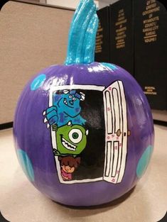 a purple pumpkin with an image of monsters on it