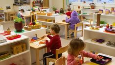 two children playing with toys in a classroom