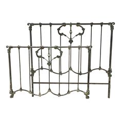 an iron bed frame with decorative designs on it