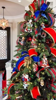 a christmas tree decorated with red, white and blue ribbons