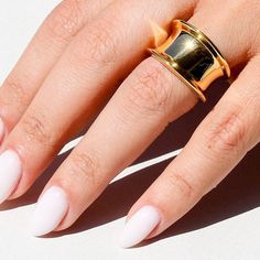 Add a touch of trendiness to your outfit with the Cylia Ring, a chunky and oversized gold ring that makes a statement on any occasion. The cylinder-shaped ring is crafted with 18K gold-plated materials, ensuring its durability and resistance to water. Geometric Design: The Cylia Ring features a unique cylinder shape, making it stand out as an eye-catching piece of geometric jewelry. Statement Piece: Its chunky size and oversized appearance ensures that it will always make an impact when worn. Suitable for all occasions or even daily wear; this trendy piece is sure to add some sparkle to your outfit - be it formal or informal! Trendy Wide Band Open Ring For Everyday, Chunky Ring, Bold Rings, Trendy Ring, Ring Fashion, Cylinder Shape, Chunky Rings, Jewelry Statement, Geometric Jewelry