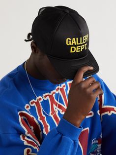 Workwear has been bleeding into menswear since the 1990s, becoming crisper, polished and more refined. Gallery Dept.'s 'Trucker' cap is made from black foam and has a breathable mesh construction. It's printed with a bold yellow moniker on the front. Gallery Dept, Guys Clothing Styles, The 1990s, Clothing Styles, Mr Porter, Trucker Cap, Caps Hats, Accessories Hats, Work Wear