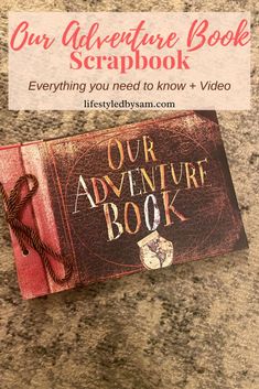 the adventure book scrapbook is sitting on top of a granite countertop next to a sign that reads our adventure book