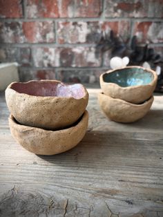 three bowls sitting on top of a wooden table