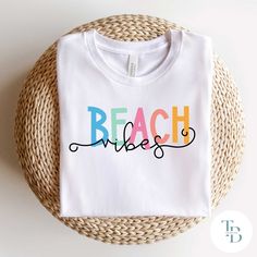 a white t - shirt with the word beach on it