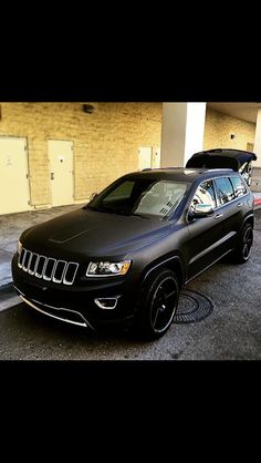 a black jeep parked in front of a building