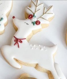 decorated cookies are sitting on top of each other in the shape of deers and snowflakes