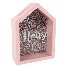 a pink house shaped box with flowers and the words house fund written in white on it