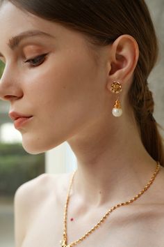 With a mesmerizing blend of contemporary flair and timeless allure, the Cleo Wrapped Pearl Drop Earrings are a true embodiment of sophistication. Each pearl is embraced by delicate gold tendrils, crafted with artisanal precision. These earrings are perfect for elevating casual-chic outfits or adding a hint of glamour to formal attire. Handmade with sustainability in mind, they offer a guilt-free indulgence in luxury, making them an essential accessory for every modern muse. Elegant Gold Plated Teardrop Clip-on Earrings, Gold Clip-on Pearl Earrings Fine Jewelry, Fine Jewelry Gold Clip-on Pearl Earrings, Elegant Brass Jewelry Tarnish Resistant, Refined Gold Jewelry With Matching Earrings, Elegant Gold-tone Earrings For Anniversary, Teardrop Gold Jewelry For Everyday Elegance, Elegant Gold-plated Teardrop Clip-on Earrings, Refined Gold Drop Earrings