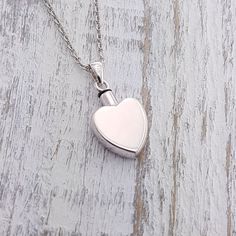 This Sterling Silver Heart Pendant measures 16 mm x 21 mm, and is 6 mm thick. I can custom engrave any letters or images you like on the front or back, please see the listing options for the list of fonts available. I have suspended this pendant from a matching silver chain, please choose your desired chain length upon checkout.  Need to secure the top permanently? A little loctite from your local hardware store can be applied to the area where you screw the capsule together and it will be permanently sealed! **Chain lengths can be customized, and I can customize the length at no additional charge. Fill Kit Included at no extra charge  -Kit includes: funnel and instructions on how to fill necklace NEED ENGRAVING? Custom Engraving Options:  -Please select your CUSTOM ENGRAVING Font Type in Silver Stainless Steel Necklace For Remembrance, Silver Heart Pendant Necklace For Remembrance, Silver Heart Necklace For Commemoration, Urn Bracelet, Ashes Necklace, Memorial Pendant, Urn Pendant, Urn Jewelry, Bar Pendant Necklace