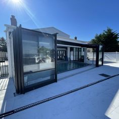 an empty swimming pool in front of a house