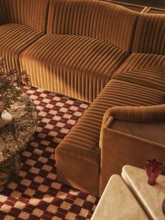 a living room filled with furniture and a checkered rug