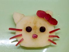 a close up of a fruit shaped like a cat