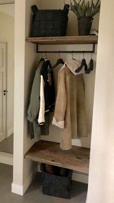 an open closet with shelves and hanging items