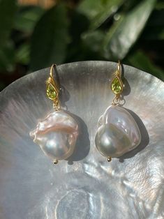 Baroque Pearl And Peridot Earrings Baroque Pearl Teardrop Earrings For Party, Single Baroque Pearl Earring In Pear Shape, Handmade Baroque Pearl Earrings In Pear Shape, Baroque Pearl Earrings Gift, High Luster Baroque Pearl Drop Earrings, Handmade Luxury Baroque Pearl Earrings, Single Pear-shaped Baroque Pearl Earring, Elegant Baroque Pearl Pendant Earrings, Baroque Pearl Pear-shaped Earrings For Gifts