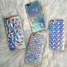 three phone cases sitting next to each other on top of a white fur covered floor