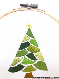 a green christmas tree is shown in the hoop