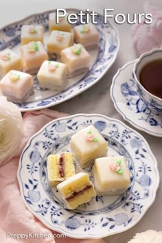 two plates with pieces of cake on them and a cup of tea in the background