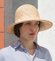 "Pine" is a feathery summer sun hat with a wide flared brim. The shapely curve of the brim ensures a perfect fit and underlines a clear, feminine look. The material "Bao" made of the undyed fibres of the baobab tree is pleasantly permeable to air and ensures maximum wearing comfort. A hoop integrated into the edge of the hat provides additional stability. Available in sizes 55 cm - 60 cm. Colour "nature" Hat of "Bao" - Monkey bread tree  Grosgrain ribbon (inside) made of 66% cotton and 34% polya Chic Cloche Sun Hat For Vacation, Chic Straw Cloche Hat With Short Brim, Chic Summer Cloche Hat, Elegant Lightweight Brimmed Straw Hat, Elegant Lightweight Sun Hat For Spring, Classic Bucket Hat For Summer Beach, Chic Lightweight Boater Hat With Short Brim, Classic Cloche Hat For The Beach, Classic Summer Bucket Hat For Beach