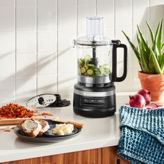 a blender sitting on top of a counter next to a plate with food in it